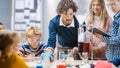 Elementary School Science Classroom: Enthusiastic Teacher Explains Chemistry to Diverse Group of Royalty Free Stock Photo