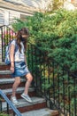 Elementary school student in a cloth dust mask with backpack in the street. Preteen girl is going to school in new