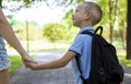 An elementary school student on his way to study. A first grader holds his mother& x27;s hand. The beginning of classes Royalty Free Stock Photo