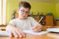 Elementary school student writing in notebook during class Royalty Free Stock Photo