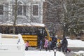 Elementary School Students Accompanied by Parents Boarding School Bus in Blizzard Snow Storm Royalty Free Stock Photo