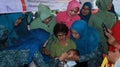 Elementary school students being given polio vaccine droplets