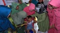 Elementary school students being given polio vaccine droplets