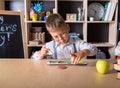 Elementary school. Talented child. Teachers day. School kids. Back to school. Kid is learning in class on background of blackboard Royalty Free Stock Photo