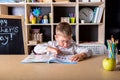 Elementary school. Talented child. Teachers day. School kids. Back to school. Kid is learning in class on background of blackboard Royalty Free Stock Photo