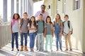 Elementary school teacher and his pupils in school corridor Royalty Free Stock Photo