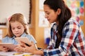 Elementary school teacher and pupil using tablet computers Royalty Free Stock Photo