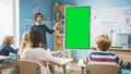 Elementary School Teacher Uses Interactive Digital Whiteboard With Green Screen Mock-up Template. He Royalty Free Stock Photo