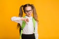 Elementary Student Girl Gesturing Thumbs Down Disapproving Something, Studio Shot Royalty Free Stock Photo