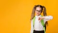 Elementary Student Girl Gesturing Thumbs Down Disapproving Something, Studio Shot Royalty Free Stock Photo