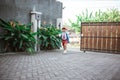 Elementary student wearing school uniform running toward his parent Royalty Free Stock Photo