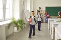 Group of happy elementary school children leaving the classroom at the end of the lesson Royalty Free Stock Photo