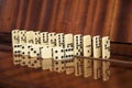 The elements of the board game domino are lying, standing arranged on a wooden background Royalty Free Stock Photo