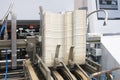 Elements of corton boxes are collected in stack. Conveyor line for the production of boxes. Machine cuts cardboard boxes from shee Royalty Free Stock Photo