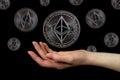 Elements of the ethereum classic cryptocurrency fall on the hand