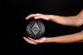 Elements of the ethereum classic cryptocurrency fall on the hand