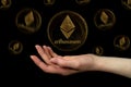 Elements of the ethereum cryptocurrency fall on the hand