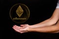 Elements of the ethereum cryptocurrency fall on the hand