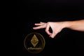 Elements of the ethereum cryptocurrency fall on the hand