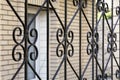 Elements are fragments of a detail of a forged black painted decorative fence made of metal. House fencing, grille, protection, Royalty Free Stock Photo