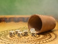 Elements of gambling on a carved wooden board figures five, green background and smoke