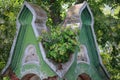 Elements of an old brick ancient building among a green plant