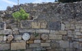 The elements of the wall of a ruined ancient house. Beautiful background of the ruins of Greek cities.