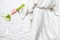 Elements of a woman`s casual suit with a bouquet of callas