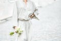 Elements of a woman`s casual suit with a bouquet of callas