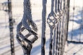 Elements of a wrought iron fence covered with snow. Snowy winter background. Royalty Free Stock Photo