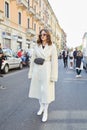 Eleonora Carisi with white coat and boots before Sportmax fashion show, Milan Fashion Week street style on