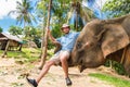 Elephan lifting a tourist.