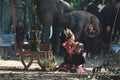 Thai native women and children sitting by offering sacrifice for elephants in the morning
