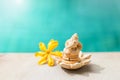 Elephant clay sculpture with yellow flower over blurred blue water background
