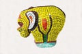 An elephant figurine made of a mosaic of yellow red color isolated on a white background.