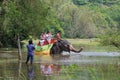 Elephant with a group of European women tourists on the overgrown pond. Elephant Safari in the vicinity of Sigiriya