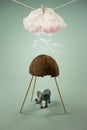 Elephant hiding from a storm under half cracked coconut. Kid toy animal. Lightning strikes from cloud hanging on a rope