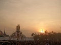 Elephant sculpture under evening light over Grand Palace and Thai people