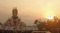 Elephant sculpture under evening light over Grand Palace and Thai people