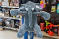 Elephant soft toy in the hands of a parent on the background of a store. April 13, 2022 Balti Moldova