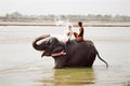 Elephant spalshing female tourist, Nepal