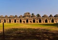 Elephant Stable in Hampi front view with blue sky in background and lawn in fore ground of the image