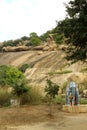 A elephant statue in front of the hill at a village temple complex.