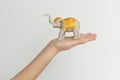 Elephant statuette on the hand isolated on white background. Royalty Free Stock Photo