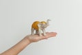 Elephant statuette on the hand isolated on white background. Royalty Free Stock Photo