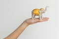 Elephant statuette on the hand on white background. Royalty Free Stock Photo