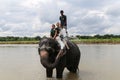 The elephant taking a shower with the tourist and driver in chitwan,Nepal Royalty Free Stock Photo