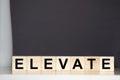 Elevate word written on wood block Royalty Free Stock Photo