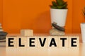 Elevate word written on wood block Royalty Free Stock Photo