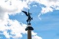 Bronze Angel Statue Soaring High Against Cloudy Sky Royalty Free Stock Photo